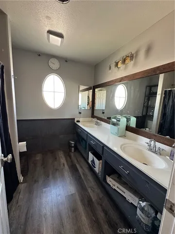 a bathroom with a double vanity sink and a mirror