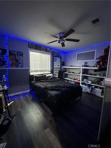 a kitchen with a stove a microwave and wooden floor