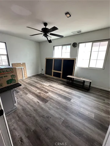 a view of room with a flat screen tv and windows