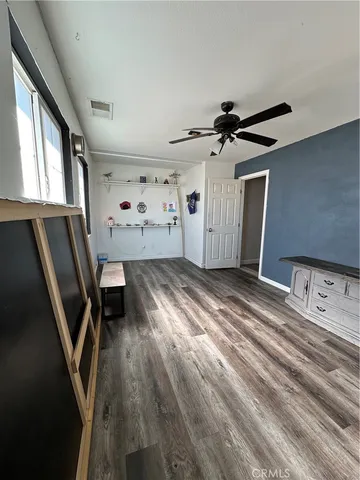 a view of a livingroom with furniture staircase and a ceiling fan