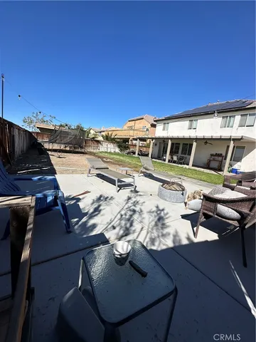 a view of a swimming pool with outdoor seating