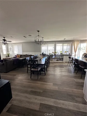 a living room with lots of furniture and kitchen view