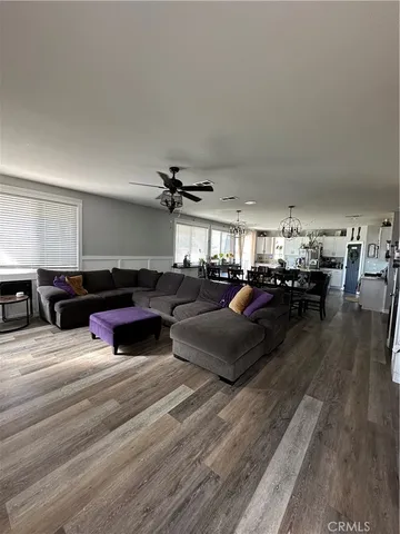 a living room with lots of furniture and a wooden floor