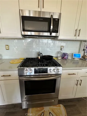a stove top oven sitting inside of a kitchen