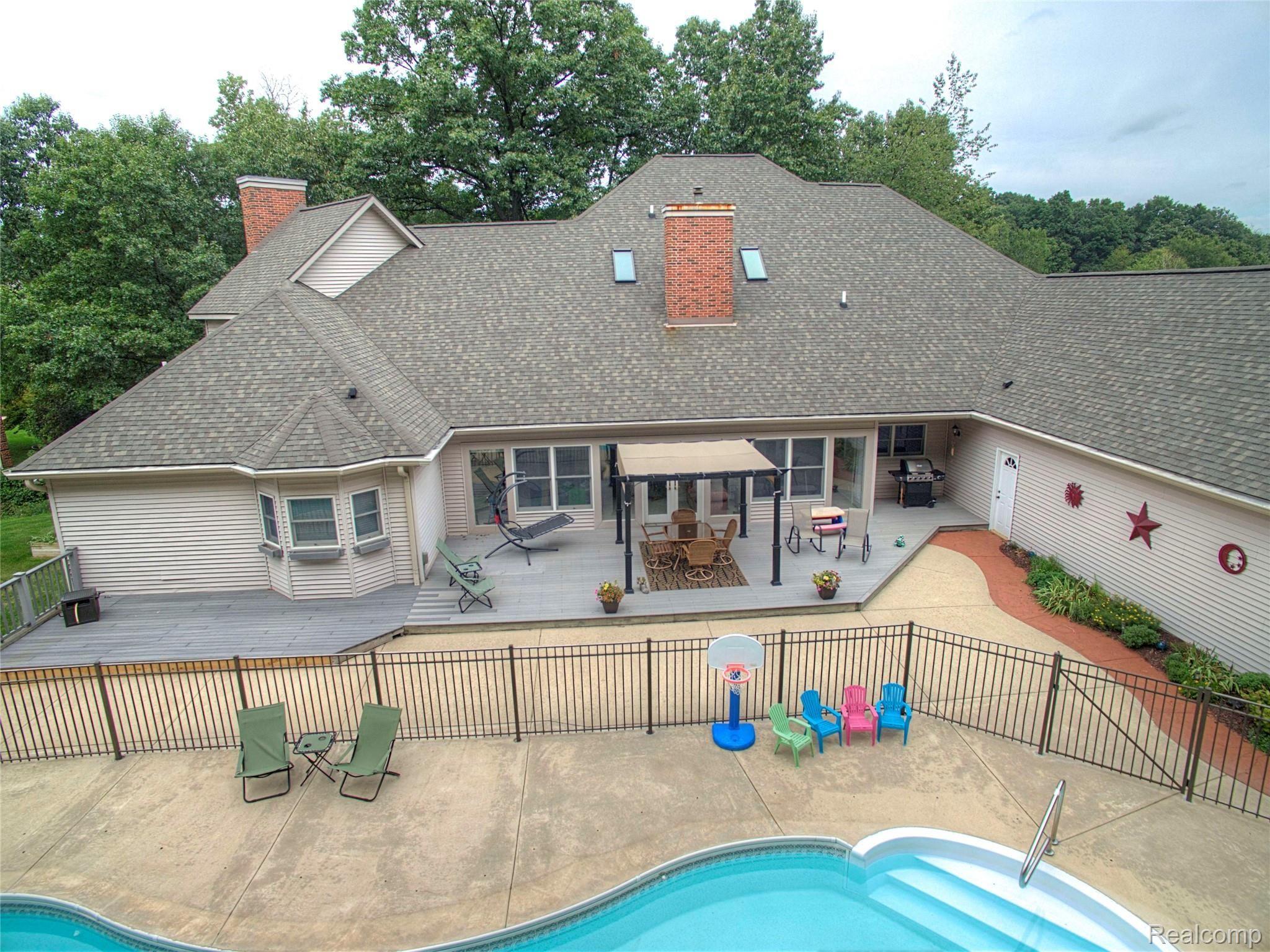 2279 Sundance Ridge Howell, MI 48843 - Photo 34 of 41 In-ground heated pool, BBQ alcove, patio and deck, is perfect for all of your outside entertainment needs.