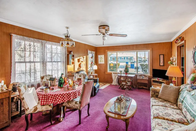 a living room with furniture a rug and a large window