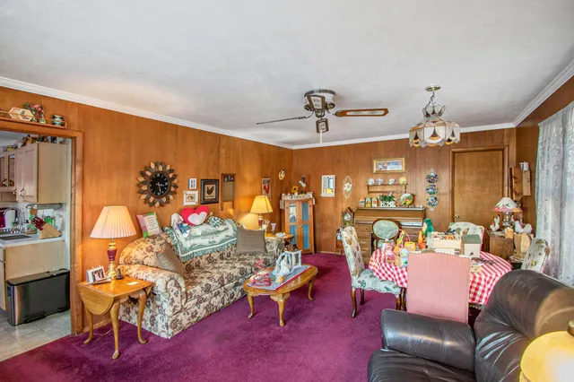 a living room with furniture and a chandelier
