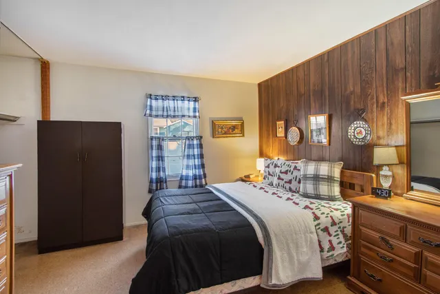 a bedroom with a bed and a dresser