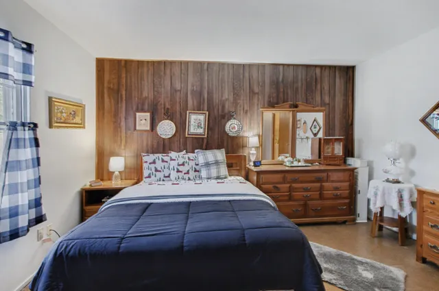 a bedroom with a bed and a dresser