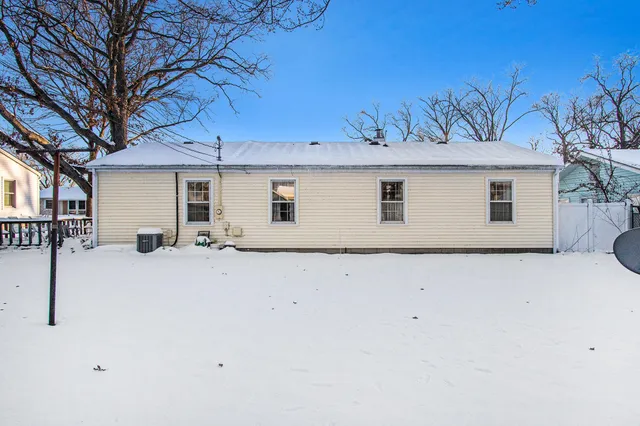 a view of a house with a snow in the yard