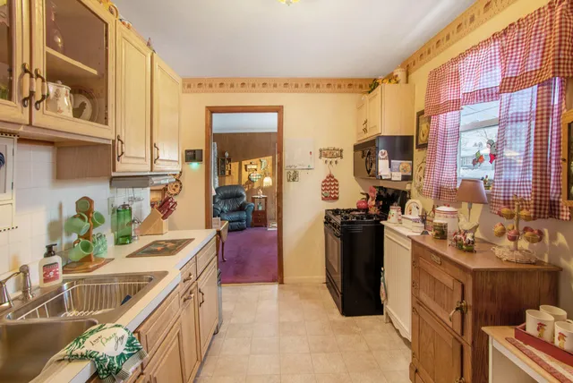a kitchen with a sink stove and refrigerator