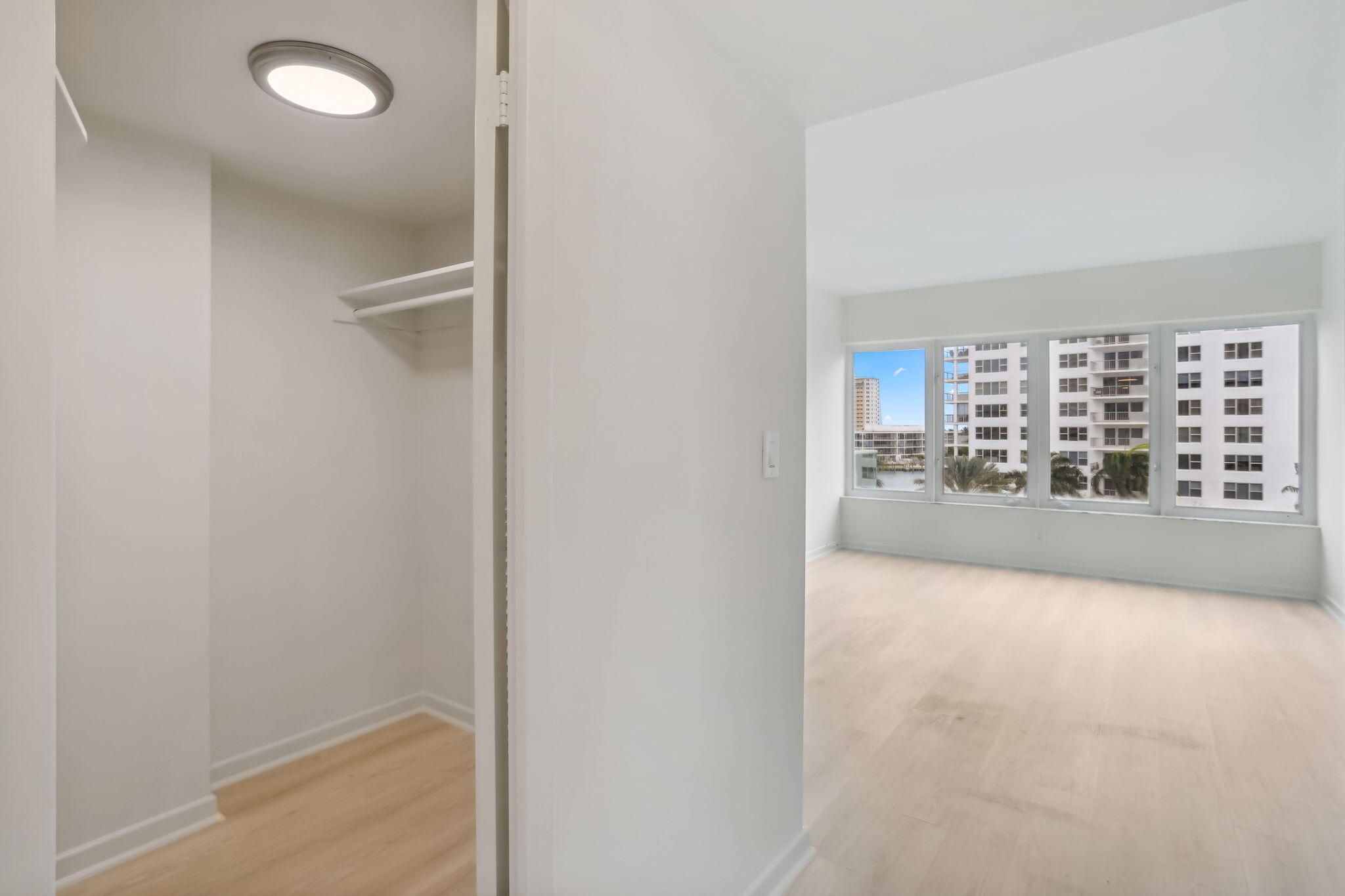 701 East Camino Real, Unit 6C Boca Raton, FL 33432 - Photo 13 of 53 a view of a hallway with wooden floor and a fireplace