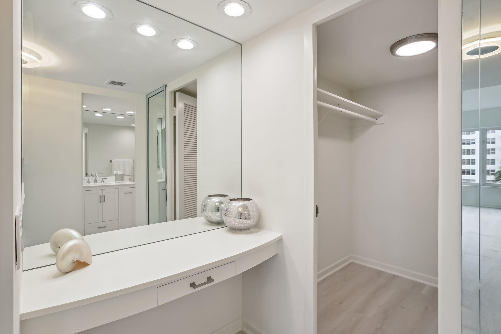 701 East Camino Real, Unit 6C Boca Raton, FL 33432 - Photo 16 of 53 a bathroom with a sink a mirror and shower