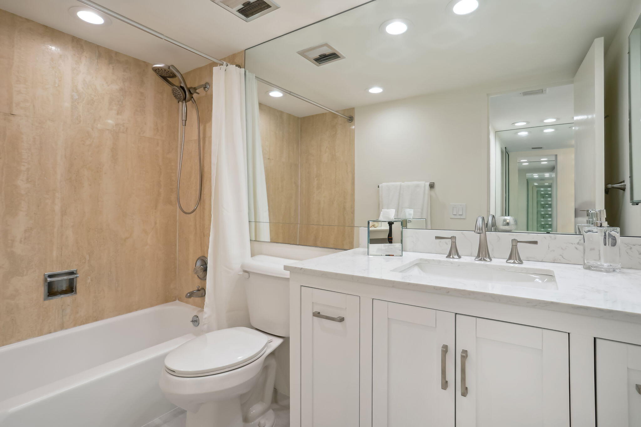 701 East Camino Real, Unit 6C Boca Raton, FL 33432 - Photo 17 of 53 a bathroom with a double vanity sink toilet mirror and bathtub