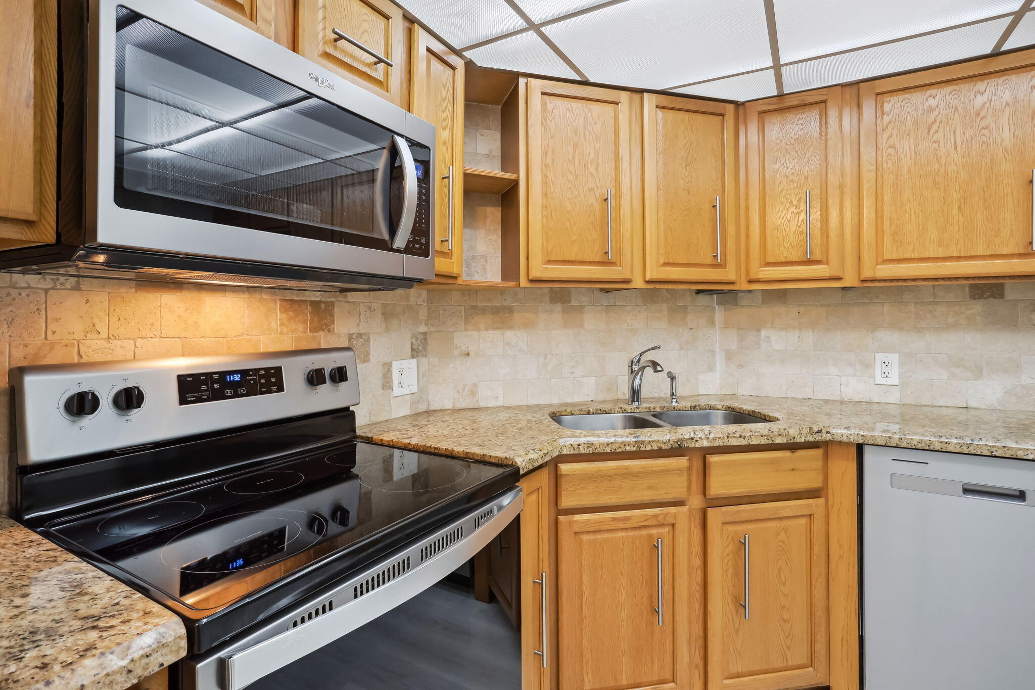 701 East Camino Real, Unit 6C Boca Raton, FL 33432 - Photo 19 of 53 a kitchen with stainless steel appliances granite countertop a sink a stove and cabinets