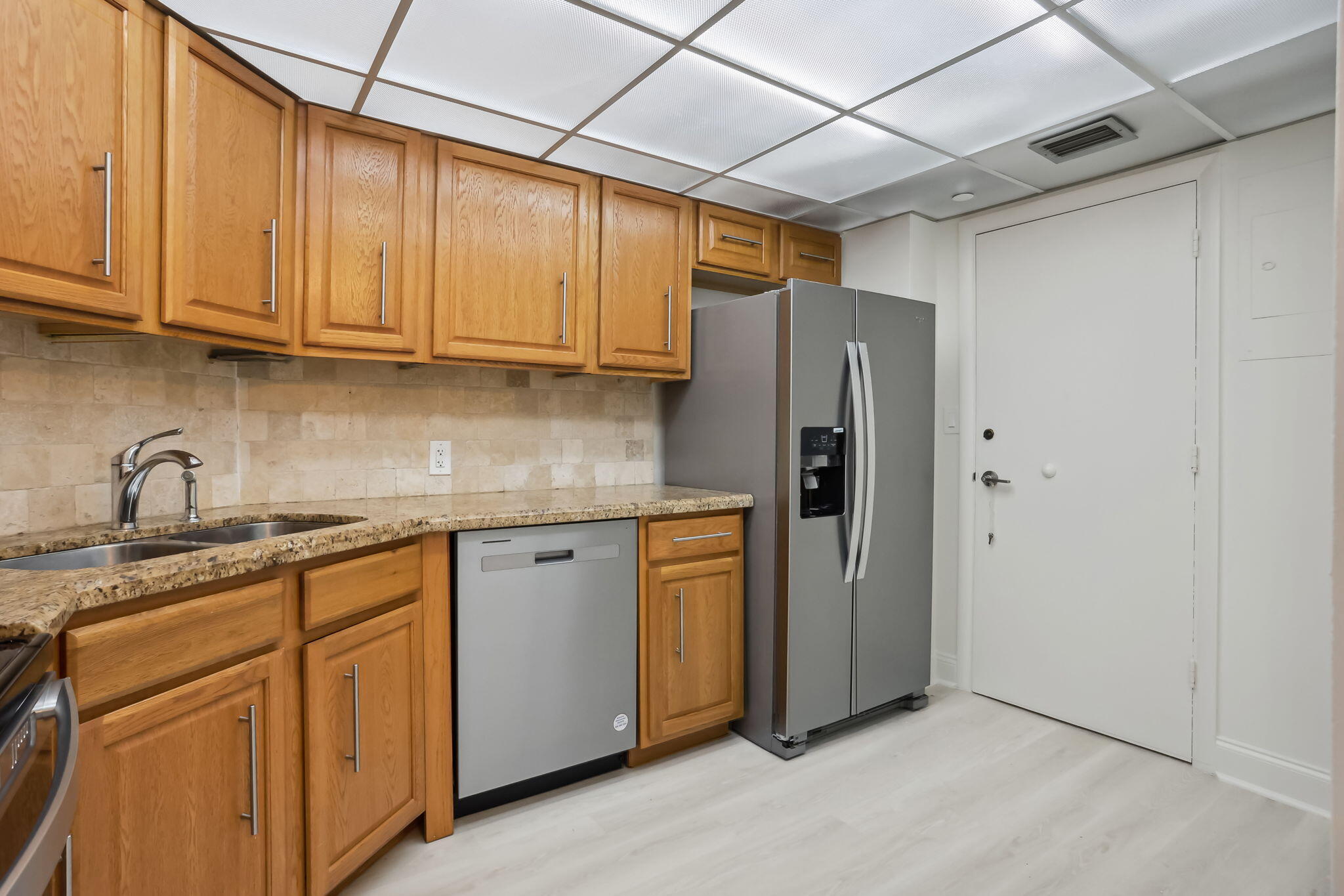 701 East Camino Real, Unit 6C Boca Raton, FL 33432 - Photo 20 of 53 a kitchen with stainless steel appliances granite countertop a refrigerator and cabinets