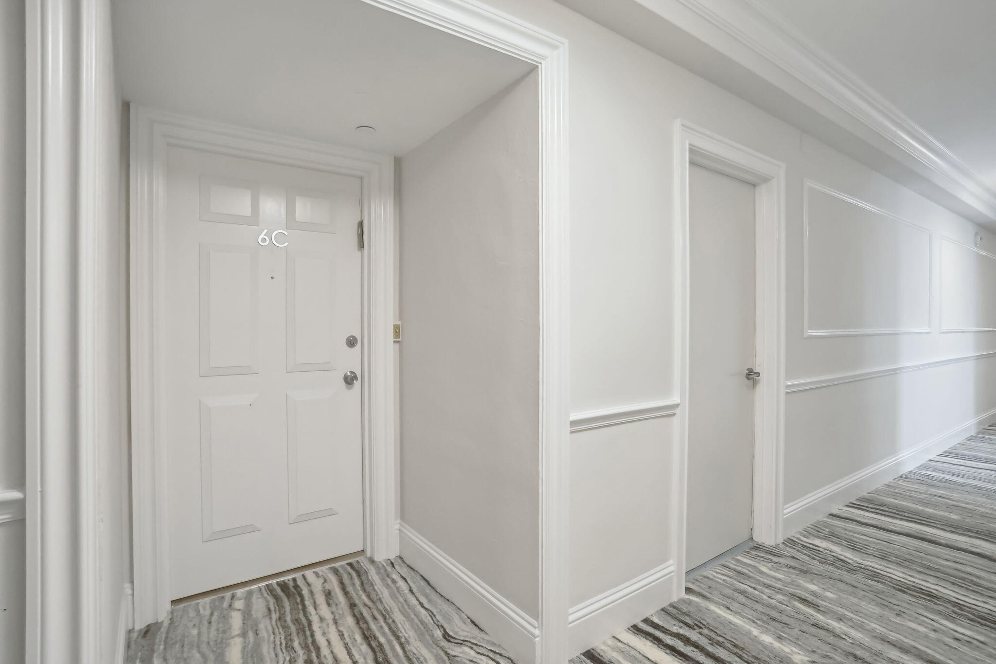 701 East Camino Real, Unit 6C Boca Raton, FL 33432 - Photo 2 of 53 a view of a hallway with wooden floor and closet