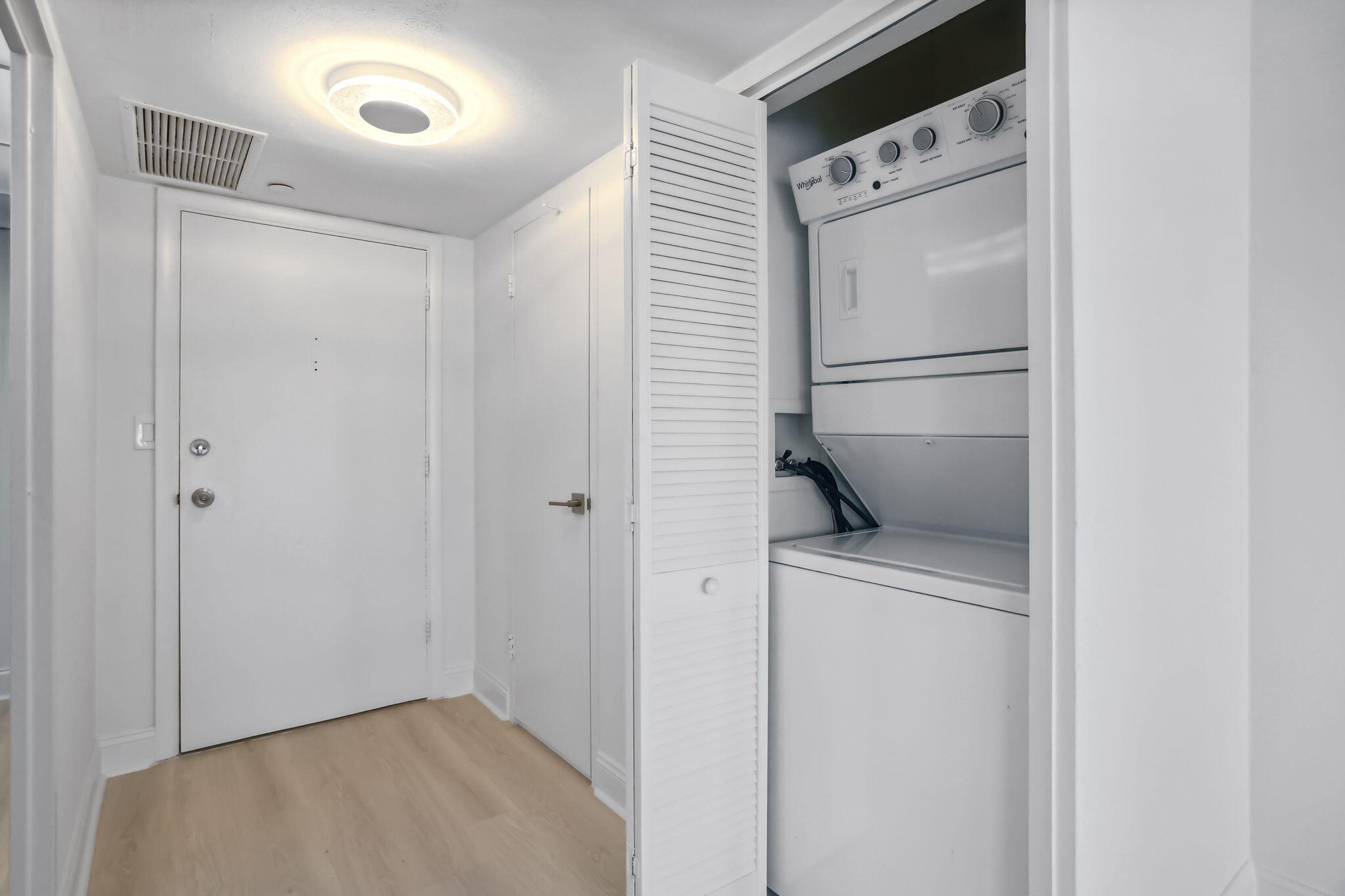 701 East Camino Real, Unit 6C Boca Raton, FL 33432 - Photo 22 of 53 a view of hallway with washer and dryer
