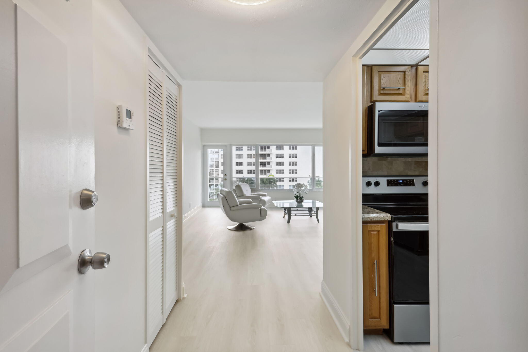 701 East Camino Real, Unit 6C Boca Raton, FL 33432 - Photo 3 of 53 a view of empty room with wooden floor and fireplace
