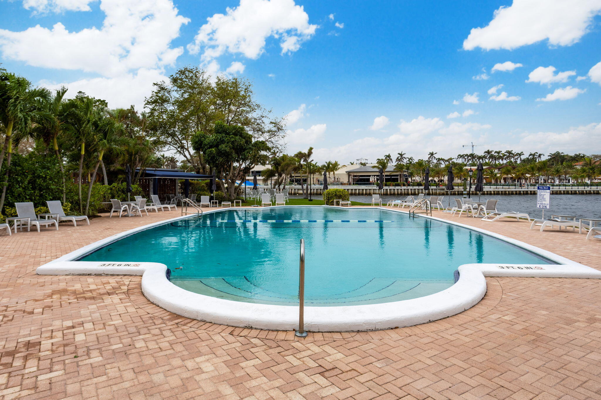 701 East Camino Real, Unit 6C Boca Raton, FL 33432 - Photo 41 of 53 a view of a swimming pool with a bench