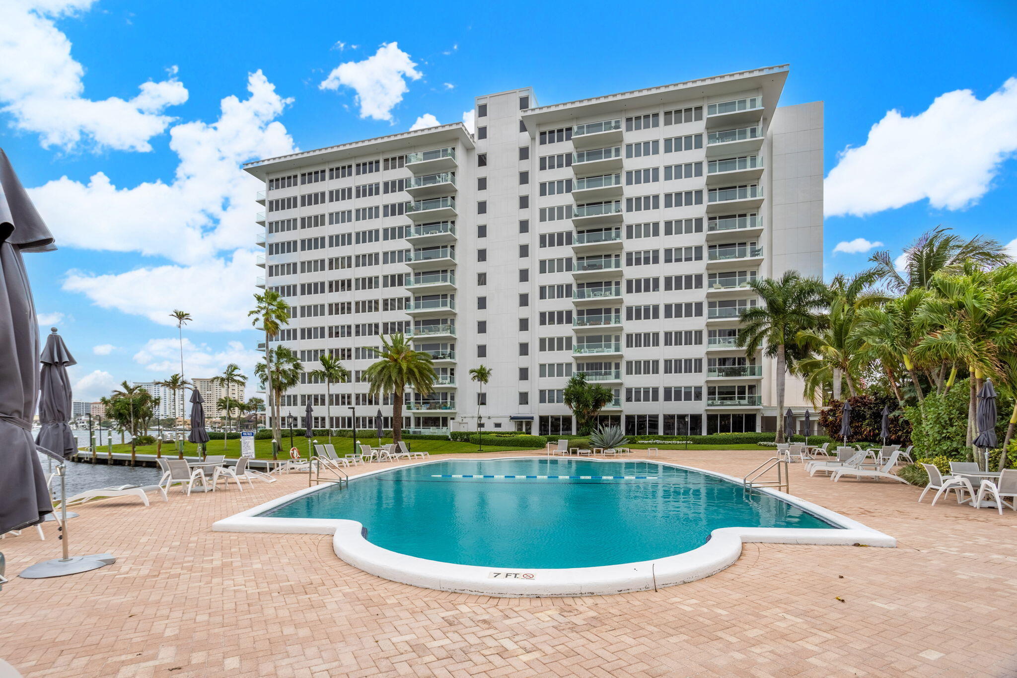 701 East Camino Real, Unit 6C Boca Raton, FL 33432 - Photo 42 of 53 a view of a swimming pool with a lounge chairs