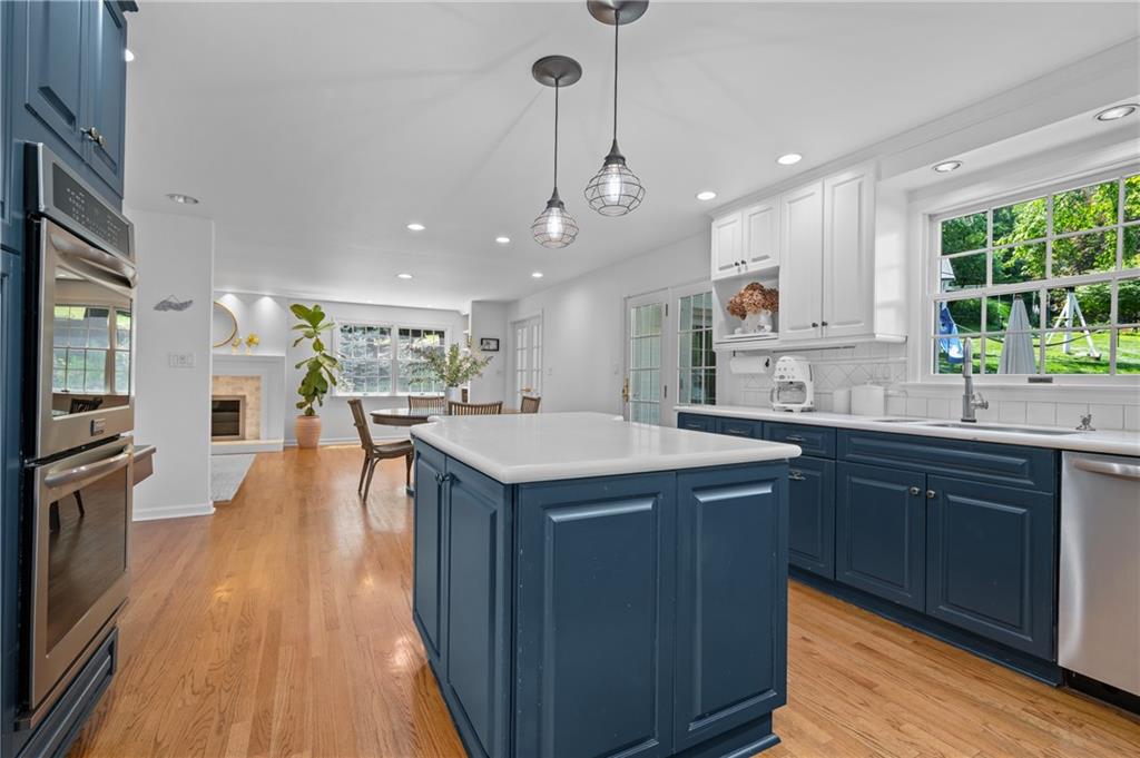 323 Cornwall Drive Pittsburgh, PA 15238 - Photo 11 of 41 a kitchen with a sink a center island wooden floor and a large window