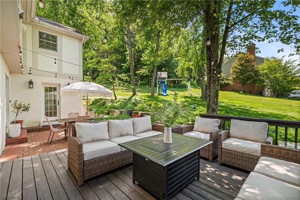 323 Cornwall Drive Pittsburgh, PA 15238 - Photo 18 of 41 a view of a patio with couches and a table and chairs with wooden floor and fence
