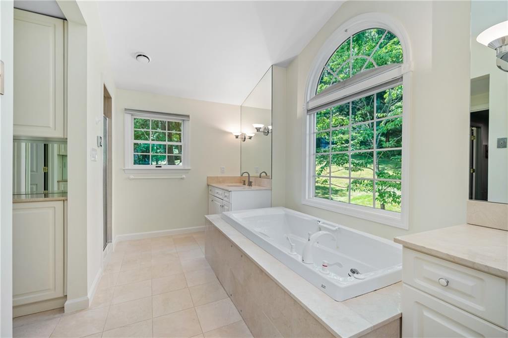 323 Cornwall Drive Pittsburgh, PA 15238 - Photo 25 of 41 a bathroom with a tub a sink and a window