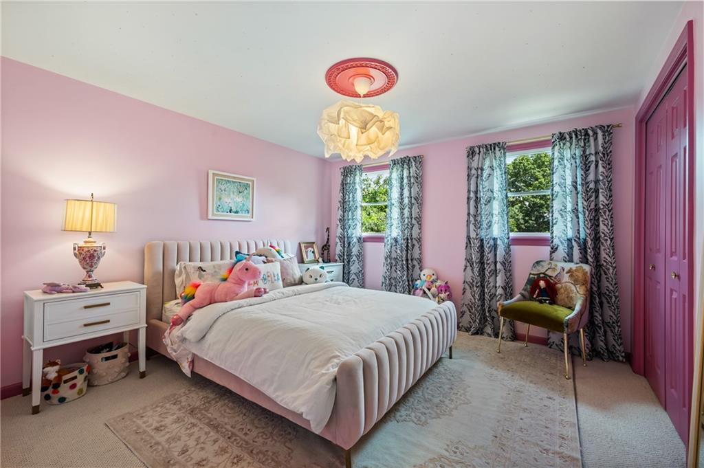 323 Cornwall Drive Pittsburgh, PA 15238 - Photo 30 of 41 a bedroom with a bed and a chandelier