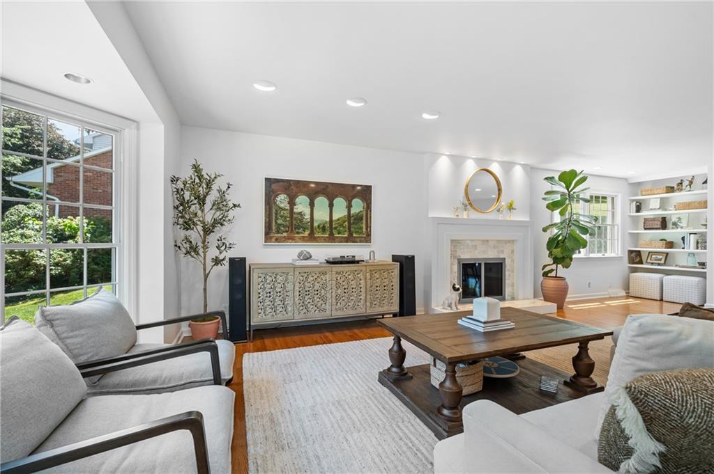 323 Cornwall Drive Pittsburgh, PA 15238 - Photo 7 of 41 a living room with furniture a fireplace and a large window