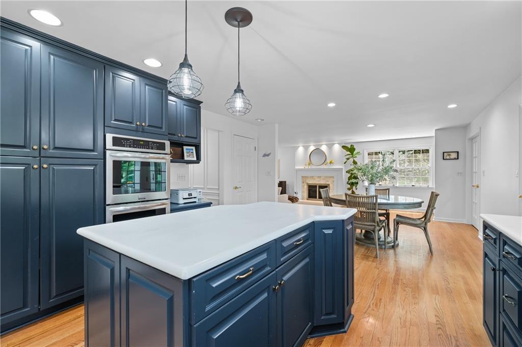 323 Cornwall Drive Pittsburgh, PA 15238 - Photo 10 of 41 a kitchen with kitchen island a wooden floor and white cabinets