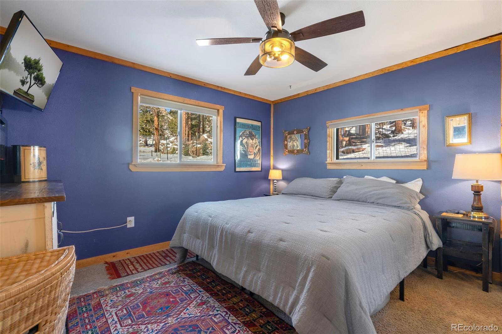 810 Larkspur Road Estes Park, CO 80517 - Photo 18 of 44 a spacious bedroom with a bed and a chandelier