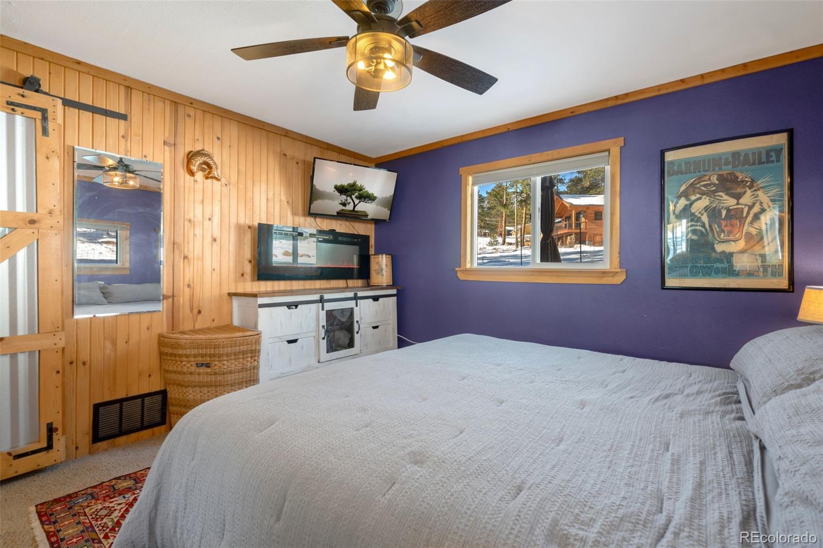 810 Larkspur Road Estes Park, CO 80517 - Photo 19 of 44 a bedroom with a bed and a flat screen tv