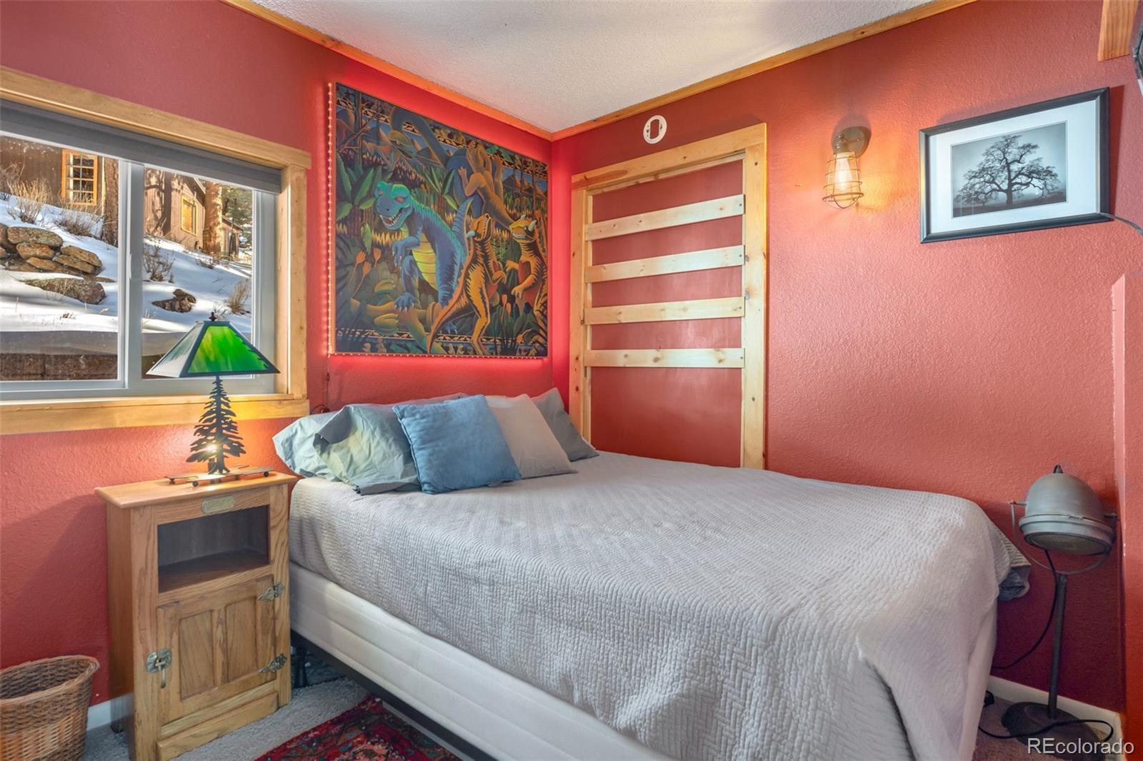 810 Larkspur Road Estes Park, CO 80517 - Photo 22 of 44 a bedroom with a bed and a window