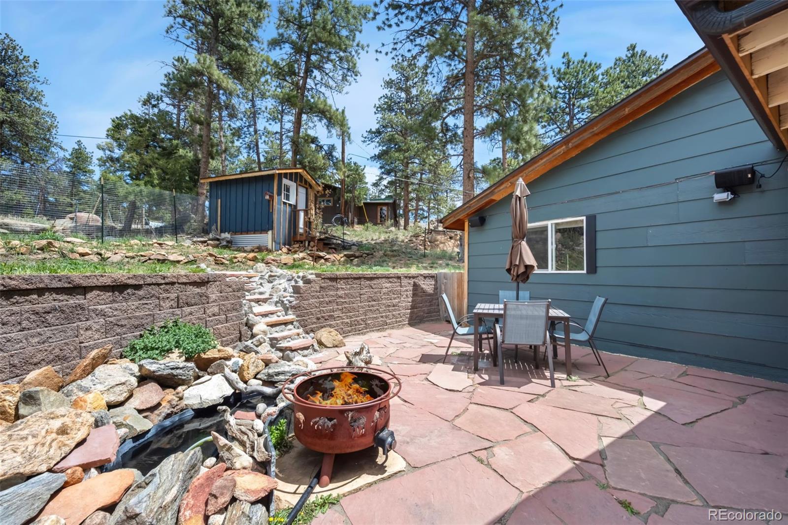 810 Larkspur Road Estes Park, CO 80517 - Photo 30 of 44 a backyard of a house with fire pit and outdoor seating