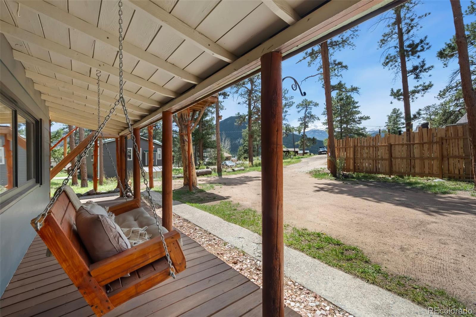 810 Larkspur Road Estes Park, CO 80517 - Photo 5 of 44 a view of a porch with furniture and wooden fence