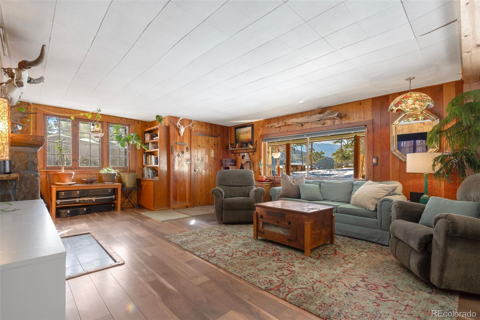 810 Larkspur Road Estes Park, CO 80517 - Photo 6 of 44 a living room with furniture and a large window