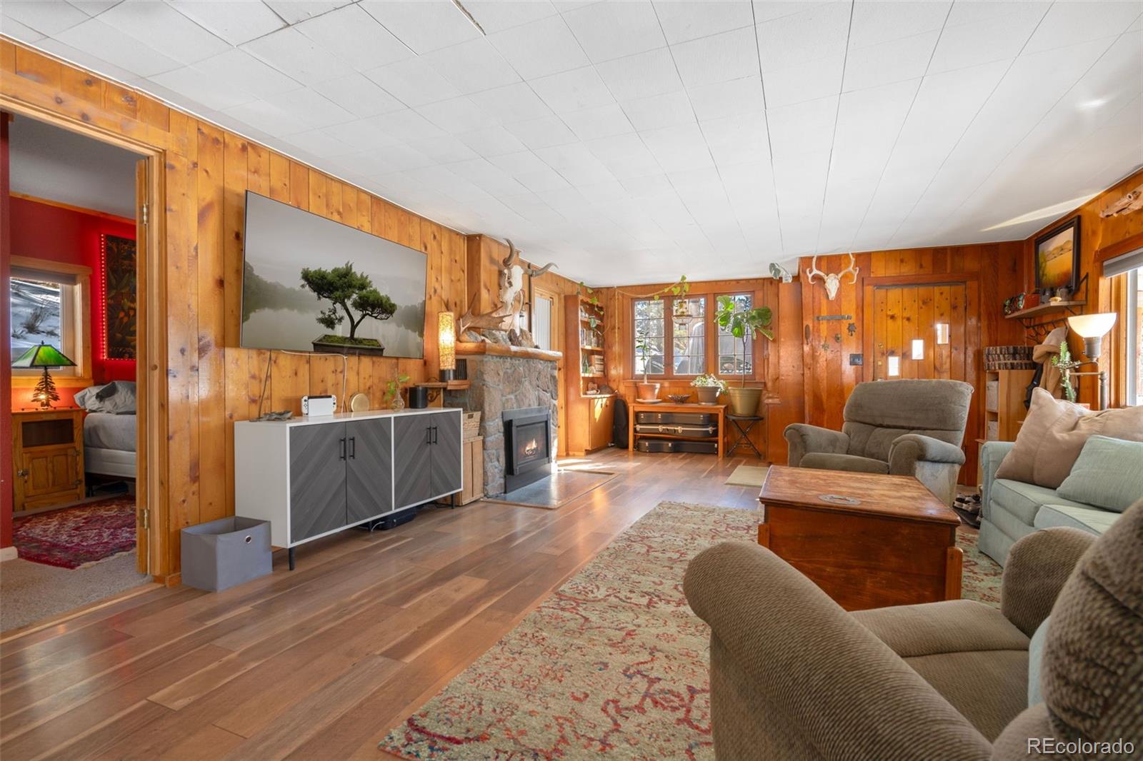 810 Larkspur Road Estes Park, CO 80517 - Photo 10 of 44 a living room with furniture and a flat screen tv