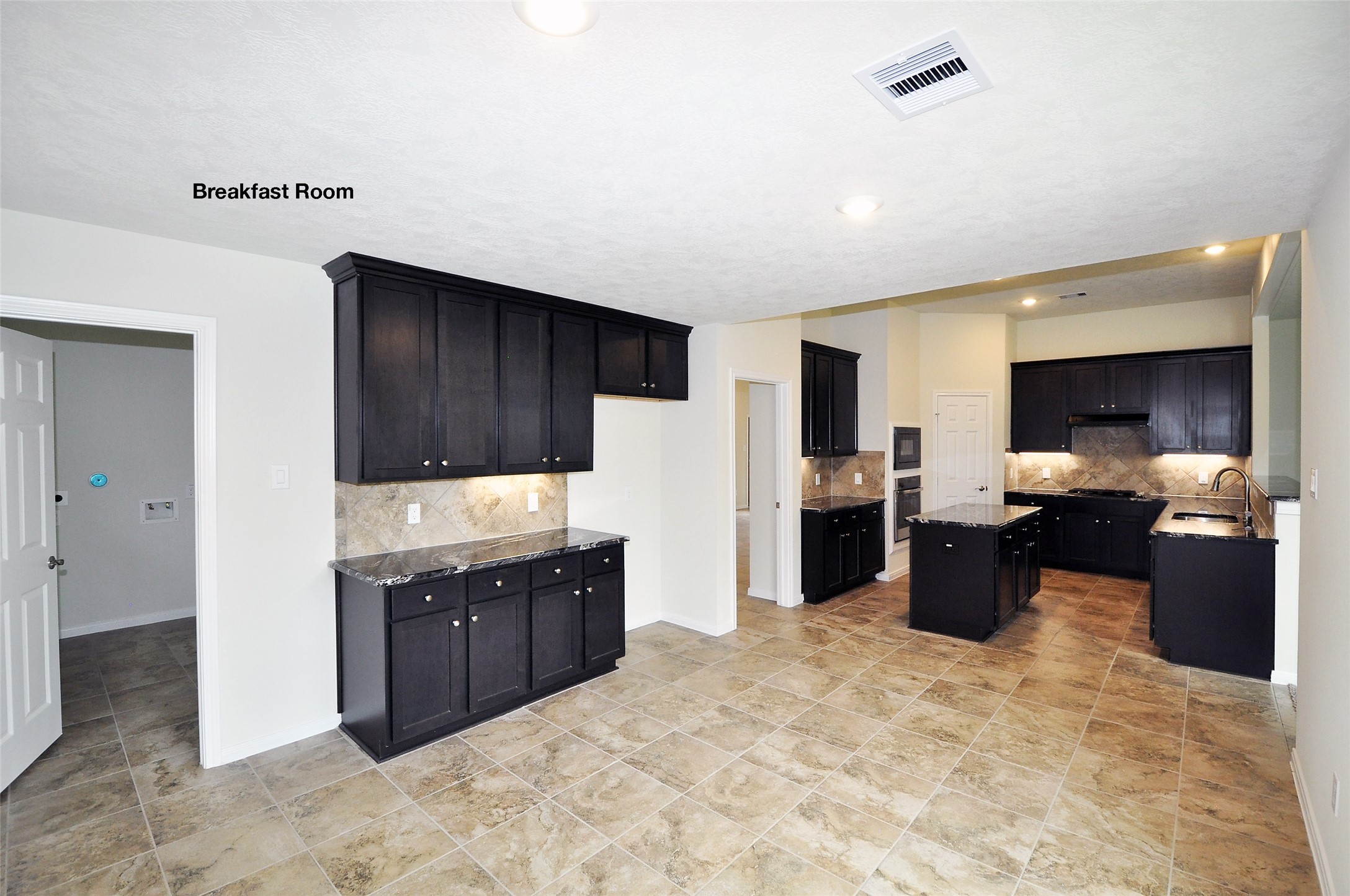 3708 Pedregal Road League City, TX 77573 - Photo 19 of 50 a kitchen with stainless steel appliances kitchen island granite countertop a refrigerator and a sink