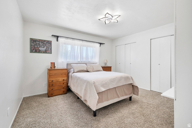 3334 Ute Road St. George, UT 84790 - Photo 17 of 40 Bedroom with multiple closets and light carpet