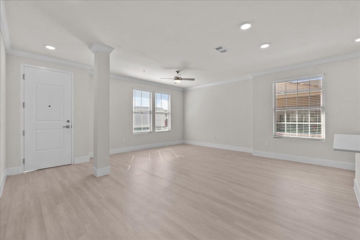 540 Hobbs Road, Unit A1 League City, TX 77573 - Photo 5 of 40 a view of an empty room with a window and wooden floor