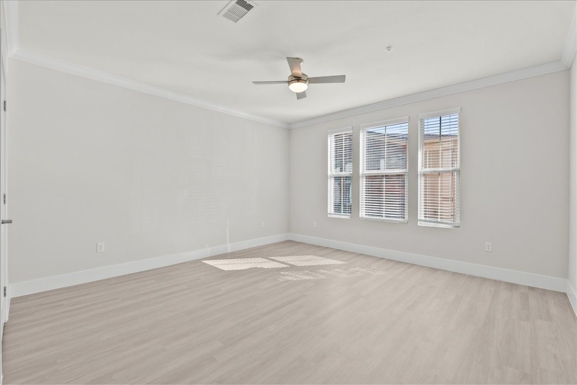 540 Hobbs Road, Unit A1 League City, TX 77573 - Photo 6 of 40 an empty room with wooden floor ceiling fan and windows