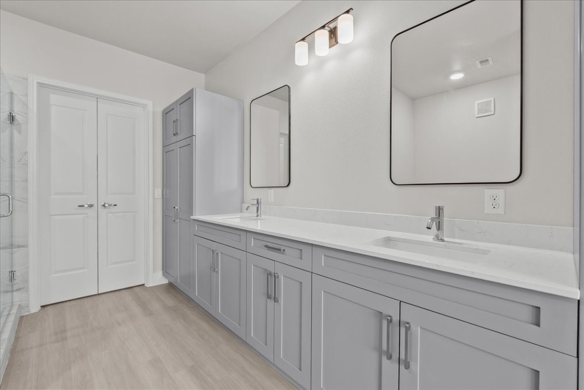 540 Hobbs Road, Unit A1 League City, TX 77573 - Photo 9 of 40 a bathroom with a double vanity sink and mirror