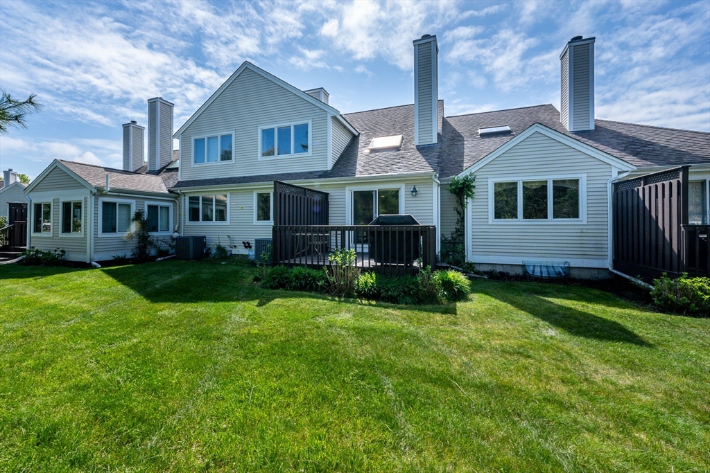 5 Classic Circle, Unit 484 Mashpee, MA 02649 - Photo 18 of 18 a front view of a house with a yard and garage