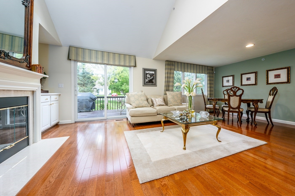 5 Classic Circle, Unit 484 Mashpee, MA 02649 - Photo 3 of 18 a living room with furniture and a fireplace