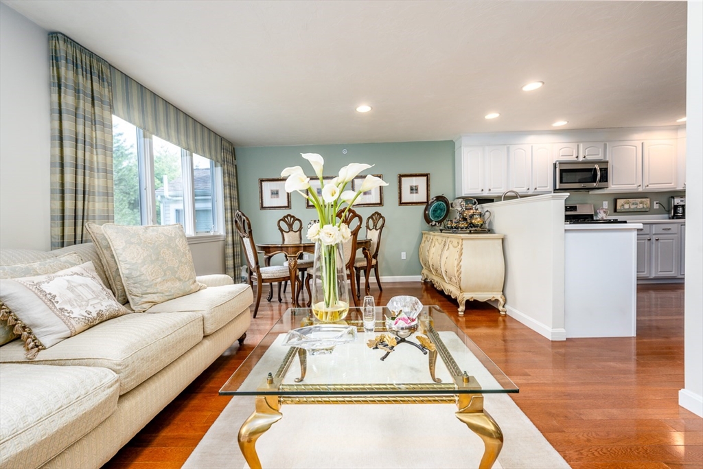 5 Classic Circle, Unit 484 Mashpee, MA 02649 - Photo 5 of 18 a living room with furniture a wooden floor and a large window