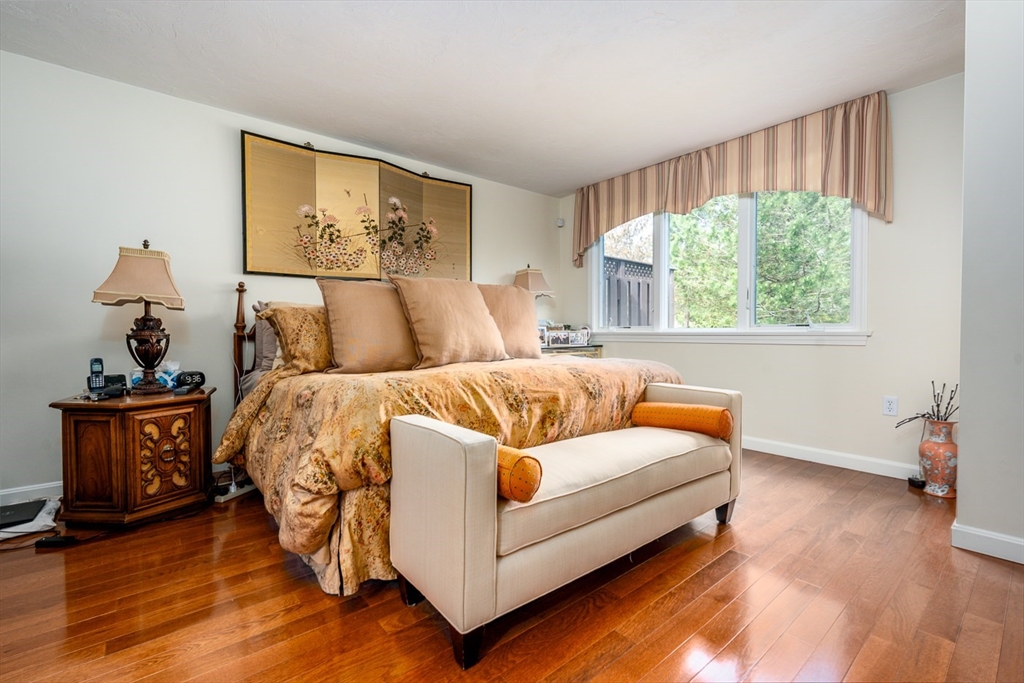 5 Classic Circle, Unit 484 Mashpee, MA 02649 - Photo 9 of 18 a bed room with a bed and a painting on the wall