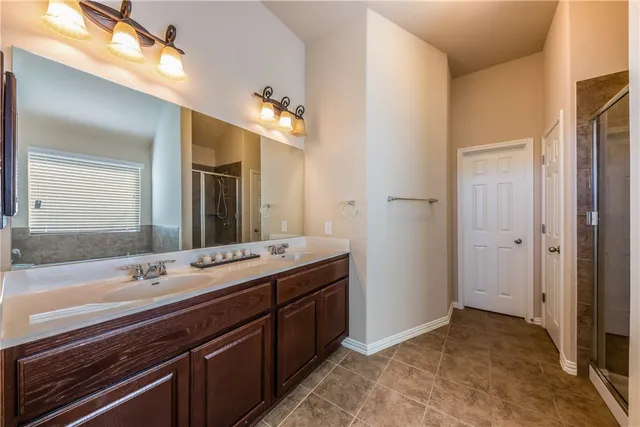 a spacious bathroom with a double vanity sink and a mirror