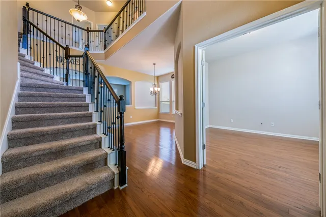 a view of entryway and hall with wooden floor