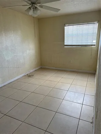 a view of an empty room and a window